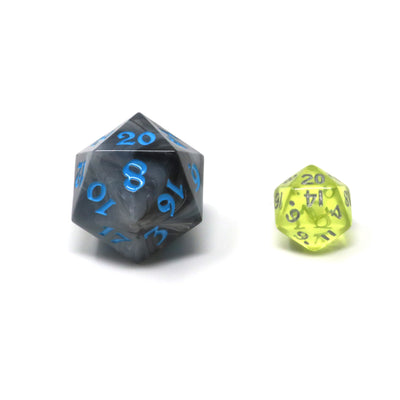 Size comparison image showing a regular sized d20 and a smaller critling d20