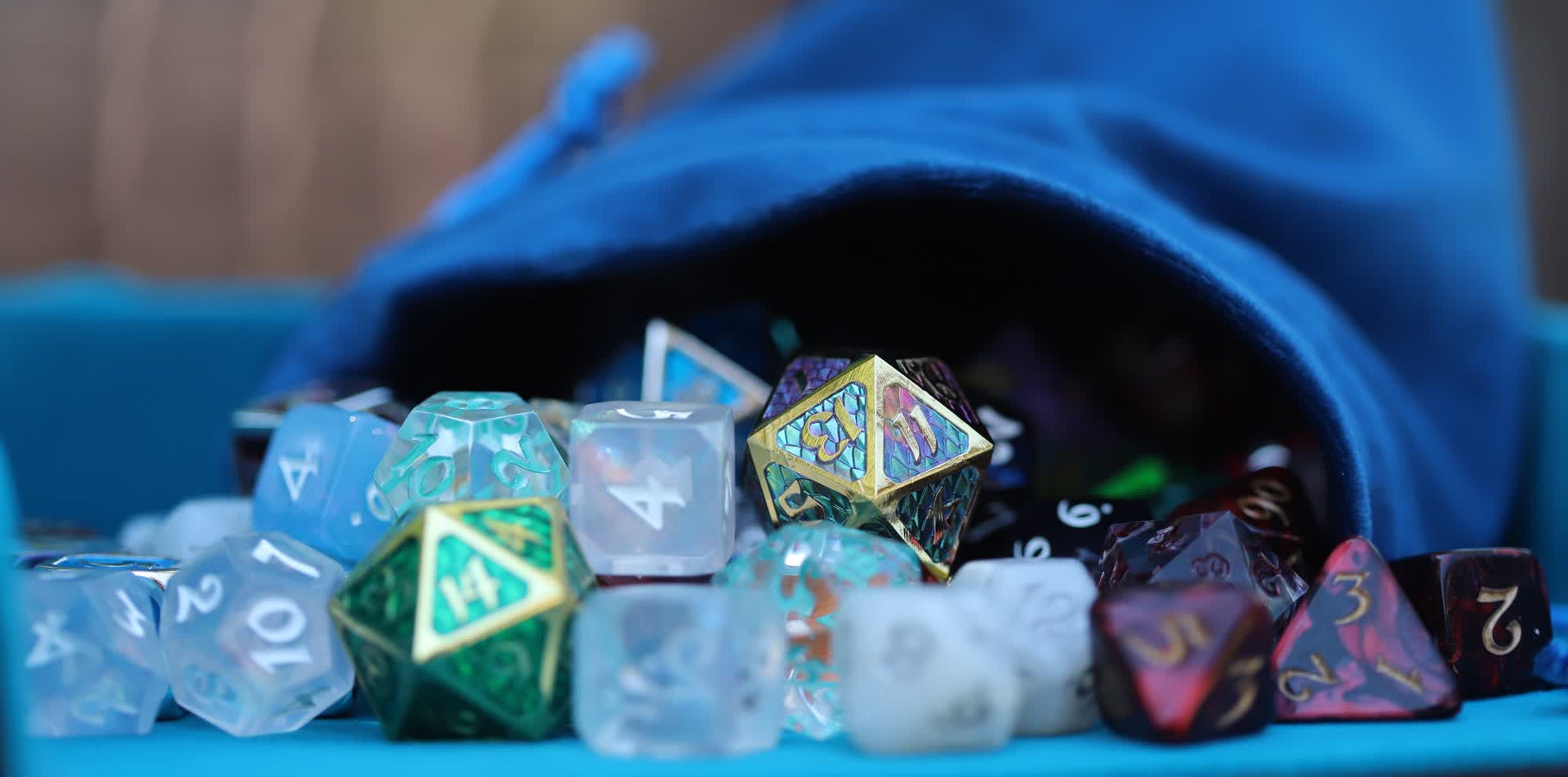  Metal and polymer dice spilling out of a blue dice bag